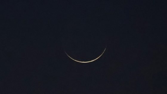 A crescent moon is seen, as Muslims attend an evening prayer session called 'Tarawih' to mark the holy fasting month of Ramadan in Karachi, Pakistan March 11, 2024. REUTERS/Akhtar Soomro
