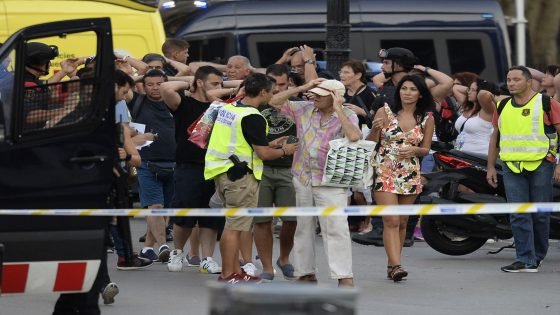 Policemen check the identity of people standing with their hands up after a van ploughed into the crowd, killing two persons and injuring several others on the Rambla in Barcelona on August 17, 2017.
A driver deliberately rammed a van into a crowd on Barcelona's most popular street on August 17, 2017 killing at least two people before fleeing to a nearby bar, police said. Officers in Spain's second-largest city said the ramming on Las Ramblas was a "terrorist attack" and a police source said one suspect had left the scene and was "holed up in a bar". The police source said they were hunting for a total of two suspects. / AFP PHOTO / Josep LAGO