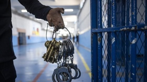 A guard carries keys and handcuffs at the prison of Kenitra, in the coastal city of the same name, near the Moroccan capital Rabat, on August 31, 2021. - After passing through the North African kingdom's Moussalaha ("Reconciliation") programme, some prisoners are hoping for a reprieve. The programme, launched in 2015 and led by Morocco's DGAPR prison service with several partner organisations, aims to help terror detainees who are willing to question their beliefs. (Photo by FADEL SENNA / AFP)
